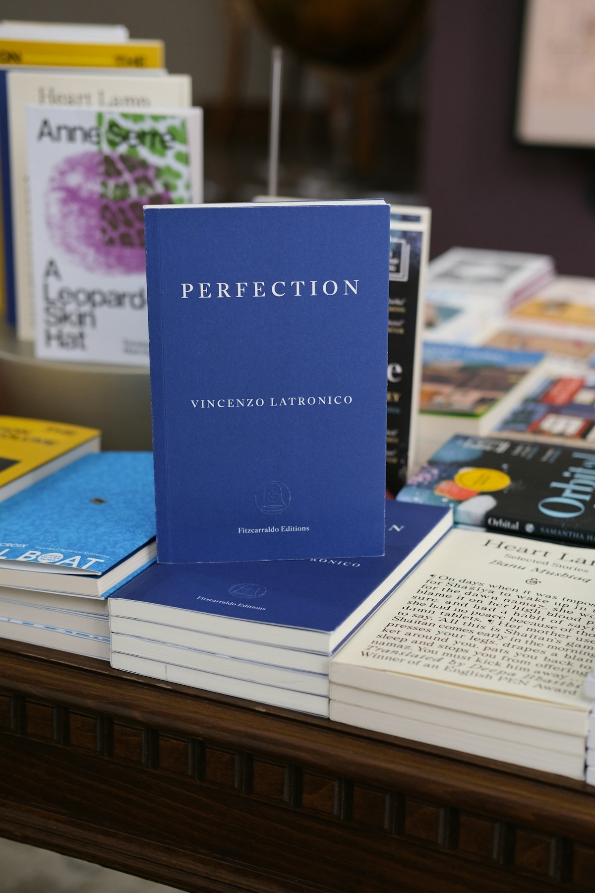 A book titled perfection is on display.